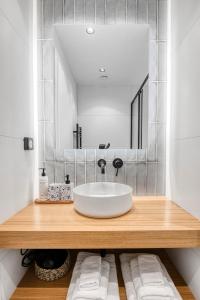 a bathroom with a sink and a mirror at Dock 38 Apartments Collection in Piraeus