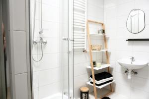 a bathroom with a shower and a sink at Nowoczesny Apartament Prudnik in Prudnik