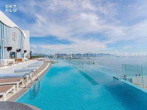 a swimming pool with a view of the water at Panorama Beach Win Nha Trang in Nha Trang