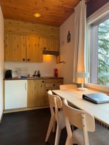 a kitchen with a table and chairs and a counter at Miraflor Sonja by Arosa Holiday in Arosa +8 photos