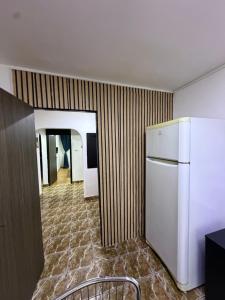 a room with a refrigerator and a hallway at Hypnotic Suite 1 in Piteşti +5 photos