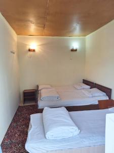 a room with three beds in a room at Сакура in Cholpon-Ata