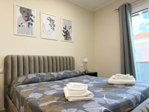 a bedroom with a bed with towels on it at Volare B&B in Reggio di Calabria