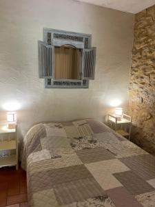a bedroom with a bed and a mirror on the wall at Chambre Thym Mas Bel Esperance in Saint-André-dʼOlérargues