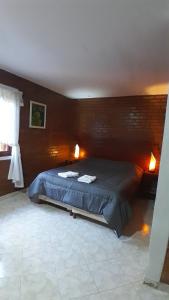 a bedroom with a bed with two towels on it at Madre America Hotel & Hostel in San Ignacio