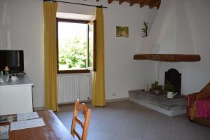 a living room with a table and a window at Martini River House in Barberino di Mugello