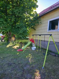 a swing set in a yard next to a house at Seaside Koster house in Strömstad +2 photos