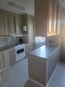 a kitchen with white cabinets and a white stove at Seaside Koster house in Strömstad