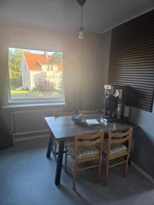 a dining room with a table and two chairs and a window at Seaside Koster house in Strömstad