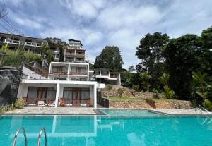 a house with a swimming pool in front of a building at Alta Vista in Ella