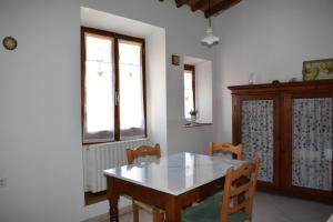 a dining room with a table and chairs and a window at Martini River House in Barberino di Mugello