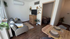 a living room with a couch and a table at Casa Capri Győr in Győr