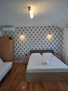 a bedroom with a bed with two towels on it at Pensiunea Turist in Techirghiol