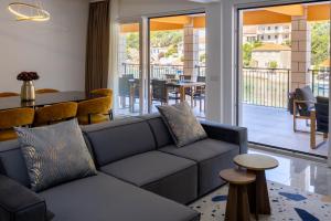 a living room with a couch and a table at Apartment Jakov Grscica in Prizba
