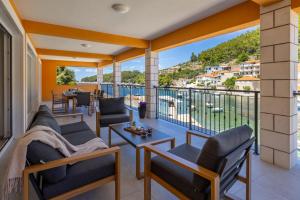 a balcony with chairs and a view of a city at Apartment Jakov Grscica in Prizba