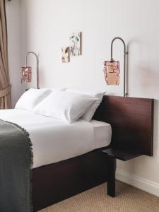 a bed with two lights on top of it at Arthouse Glasgow - Newly Refurbished in Glasgow