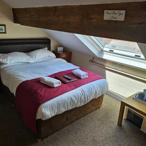 a bedroom with a bed with two towels on it at Clayhanger Guest House in Newcastle under Lyme +39 photos