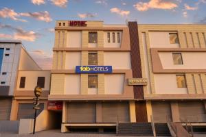 a building with a sign for a hotel at FabHotel Aqueens Plaza - Near Jawahar Circle, Patrika Gate in Siroli