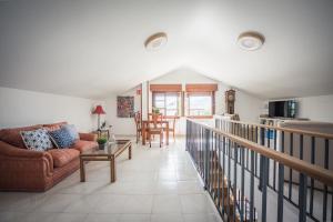 a living room with a couch and a table at Casa Rural El FerJo in Colunga