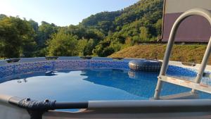 a swimming pool with a slide in the middle at Ca Giacomo in Tresana