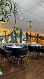 a restaurant with tables and chairs in a room at Birlik in Tengiz