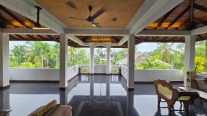 a living room with chairs and a ceiling fan at Melvila in Colombo