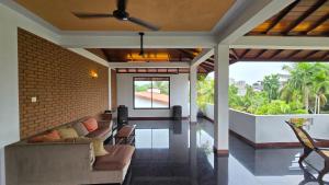 a living room with a couch and a brick wall at Melvila in Colombo
