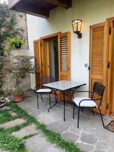 a table and chairs sitting on a patio at SecretGarden - Levico Terme in Levico Terme