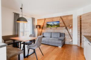 a living room with a couch and a table at Appartementhaus Reiter in Altenmarkt im Pongau
