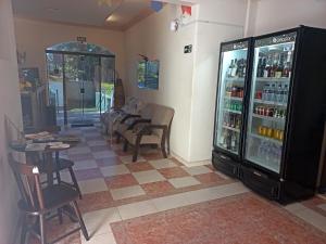 a room with a refrigerator with drinks in it at Canto do Atlântico Hotel in Guarujá