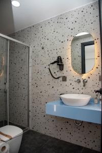 a bathroom with a sink and a mirror at Wind Alasata in Çeşme