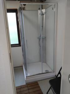 a glass shower in a bathroom with a window at JVT Cabins in Kiruna