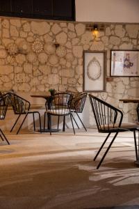four chairs and a table in a room with a stone wall at Wind Alasata in Çeşme +53 photos