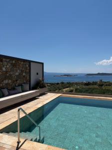 a swimming pool with a view of the ocean at Elia Luxury House in Ouranoupoli