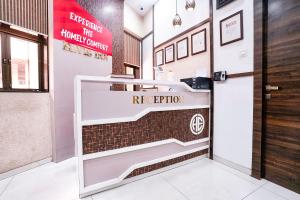 a reception desk in a lobby with a reception door at FabHotel Elvis International in Mumbai