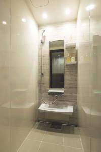 a bathroom with a sink and a mirror at Konrai Hotel Matsumoto in Matsumoto +34 photos