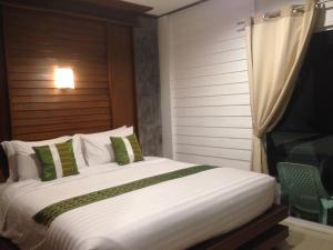 a bedroom with a large bed and a television at BaanPhong Lanta in Ko Lanta