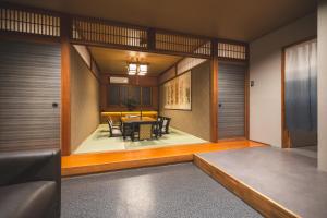 a living room with a table and a couch at Konrai Hotel Matsumoto in Matsumoto