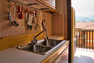 a kitchen with a stainless steel sink and a window at Barzio Coldogna 5 in Barzio +23 photos