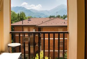 a balcony with a view of a building and mountains at Barzio Coldogna 5 in Barzio