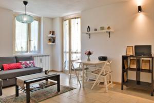 a living room with a couch and a table at Alpine studio Barzio in Barzio