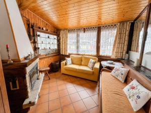 a living room with a couch and a fireplace at Zoncolan Mountain Lodge - Ride & Ski in Timau
