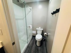 a bathroom with a toilet and a glass shower at Motel 6-Southgate, MI - Detroit in Southgate