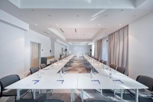 a long conference room with white tables and chairs at Holiday Inn Express - Yerevan by IHG in Yerevan +100 photos