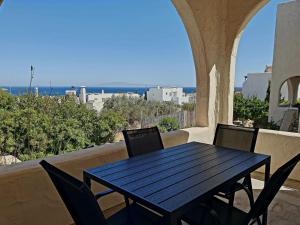 a black table and chairs on a balcony with a view at Casa Luca in Drios