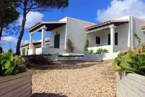 a white house with a fence and cactus at Voga Mari - Astbury Formentera in Playa Migjorn