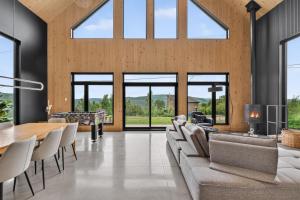 a living room with a couch and a table at Panoramic View - Spa - L'Espace-temps in Saint Come