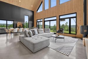 a living room with a couch and a table at Panoramic View - Spa - L'Espace-temps in Saint Come