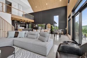 a living room with a couch and a dining room at Panoramic View - Spa - L'Espace-temps in Saint Come +58 photos