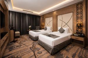 a hotel room with two beds and a television at Medhal Hotel in Jeddah +46 photos